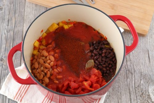 Seasonings and flavors are being added in this step to spice up with vegetarian chili.