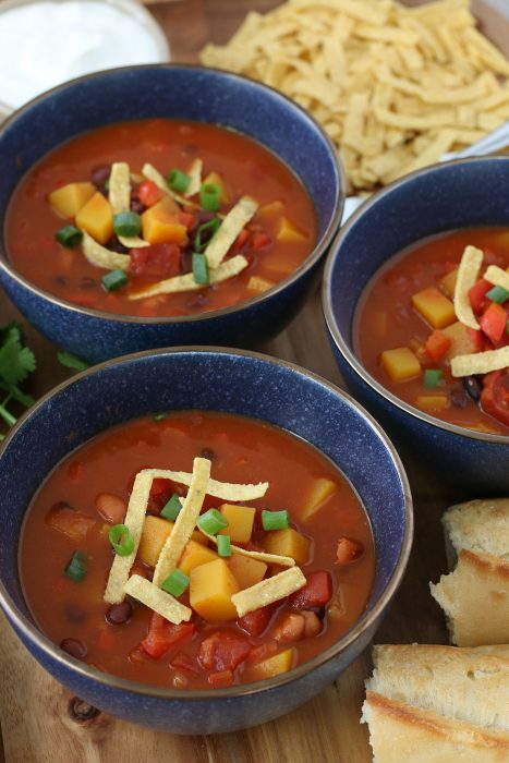 Here we see the finished butternut squash chili recipe served up in bowls with tortilla strips on top.