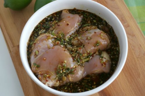 Chicken thighs marinating for a Caribbean Grille Chicken Thigh recipe.