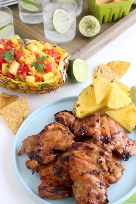 Grilled marinated chicken served with sparkling water and pineapple salsa.