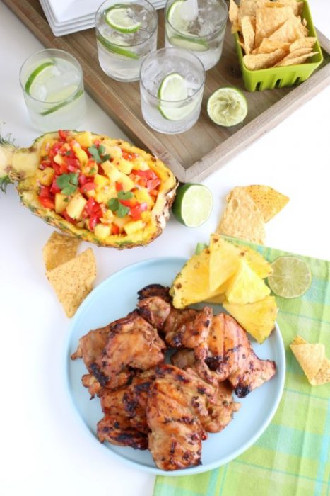 Grilled marinated chicken served with sparkling water and pineapple salsa.