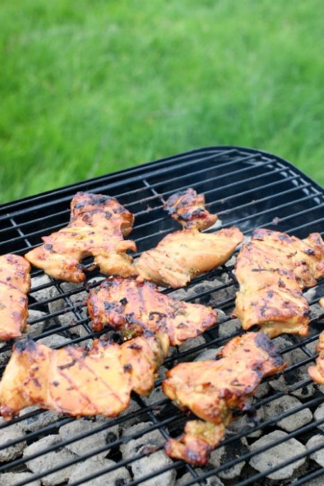 Grilled chicken thighs on the grill after cooking for 8 to 10 minutes.