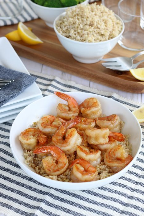 Final image of how to cook shrimp. Honey garlic shrimp in a bowl over rice, perfect for showing healthy dinner recipes with garlic shrimp. 
