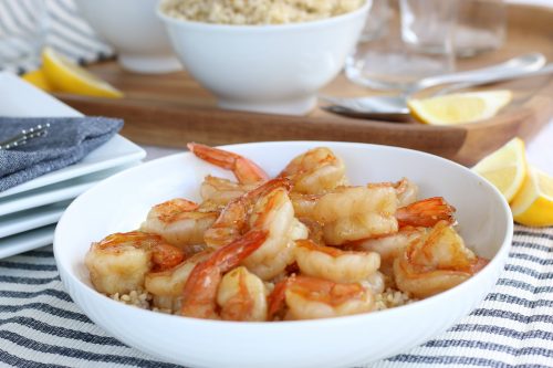 Perfectly cooked honey garlic shrimp over rice. Final product of how to cook shrimp properly! 