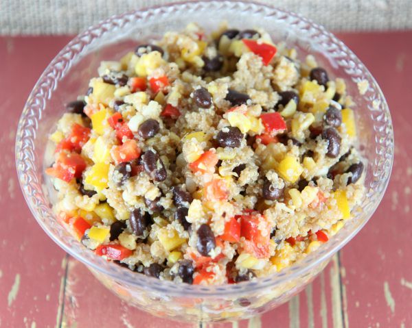 This healthy Black Bean Quinoa Salad recipe is delicious hot or cold! It makes for a great main dish for a vegetarian dinner or as a complementary side dish. It is also gluten free made with your own homemade dressing!